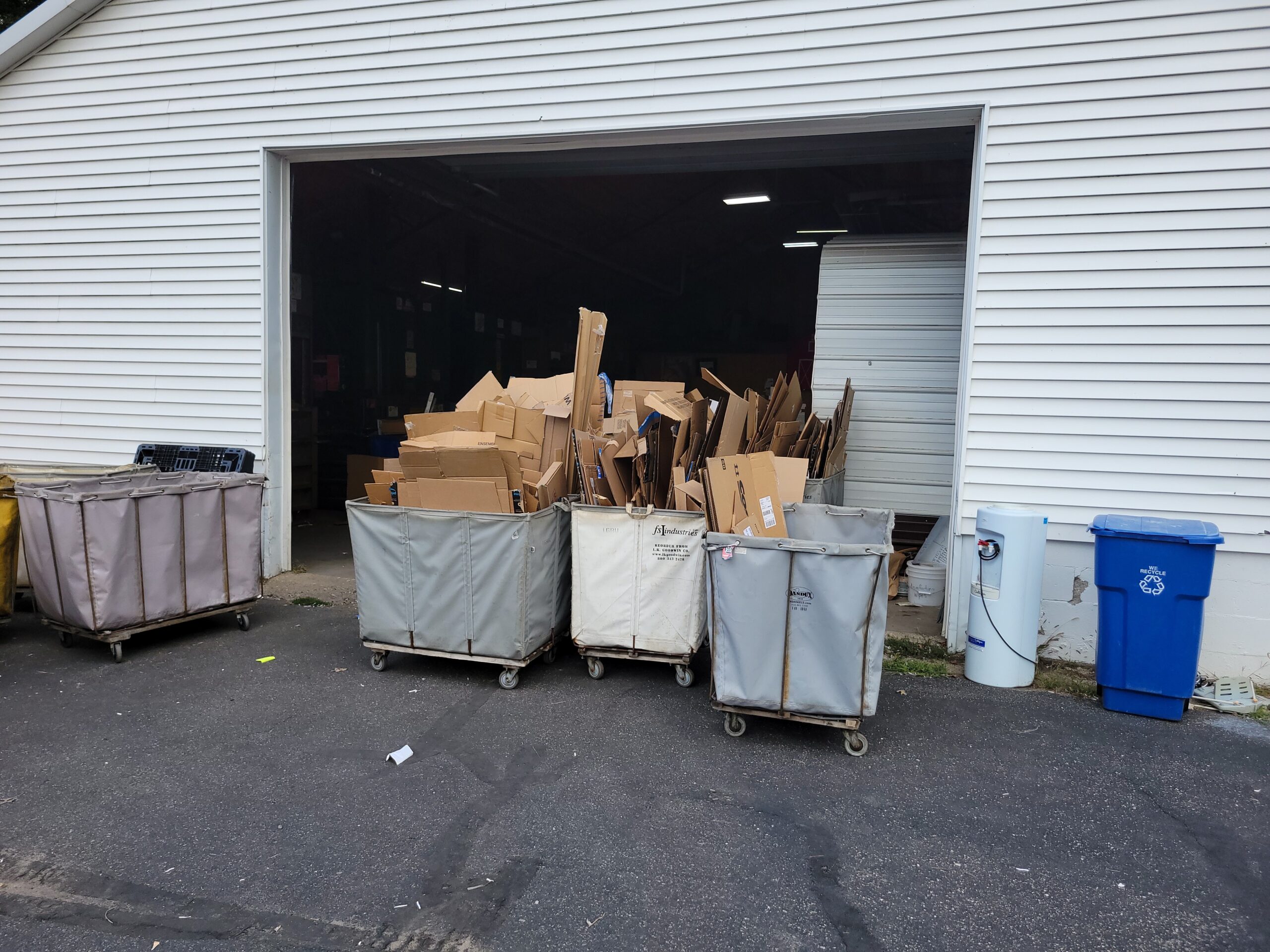 Three carts filled with cardboard collected from business pick up locations.